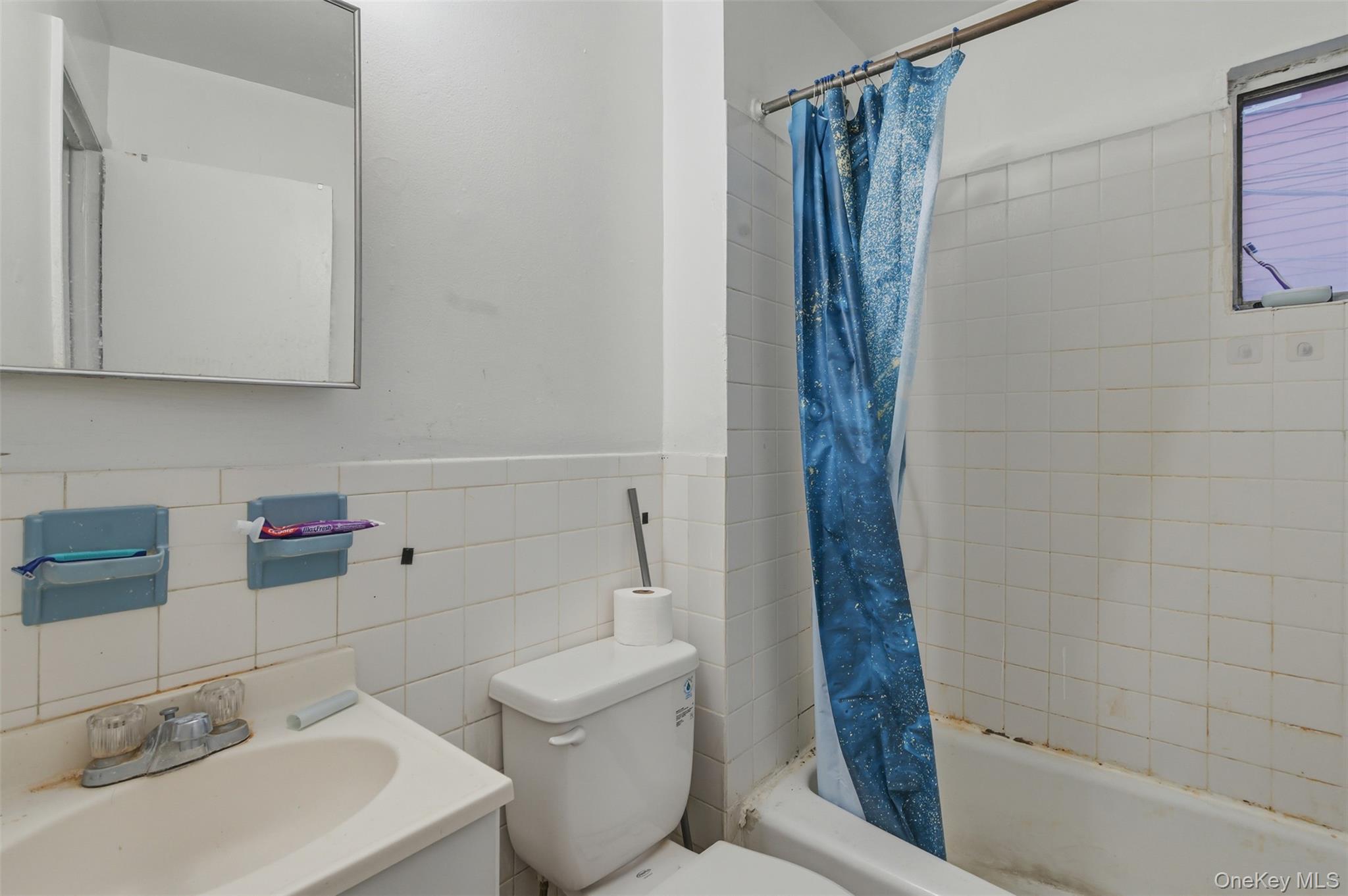 90 Conklin Avenue Haverstraw, NY 10927 - Photo 6 of 17 Full bath featuring vanity, shower / tub combo, tile walls,