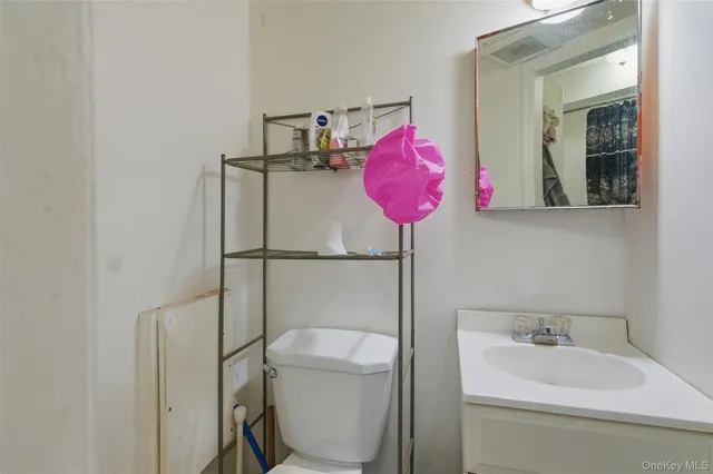 a bathroom with a sink mirror vanity and toilet