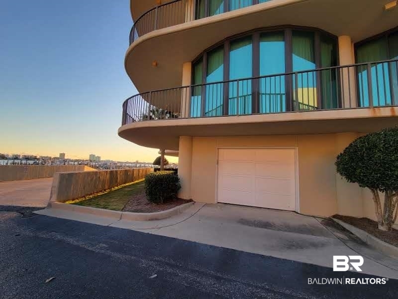 27580 Canal Road, Unit 1431 Orange Beach, AL 36561 - Photo 46 of 73 View of home's exterior with stucco siding, a balcony, and a garage