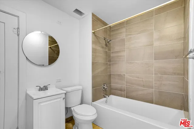 a bathroom with a toilet and a bathtub