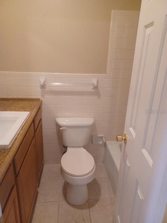 701 Perkins Street, Unit 203 Leesburg, FL 34748 - Photo 11 of 13 a white toilet sitting next to a white cabinet