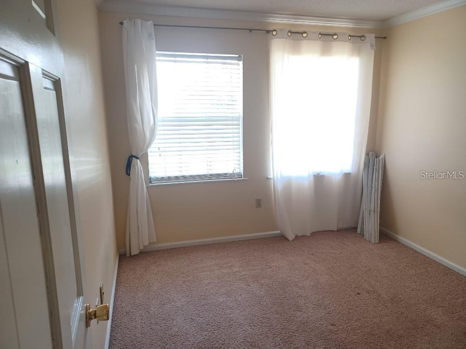 701 Perkins Street, Unit 203 Leesburg, FL 34748 - Photo 12 of 13 a view of an empty room with a window
