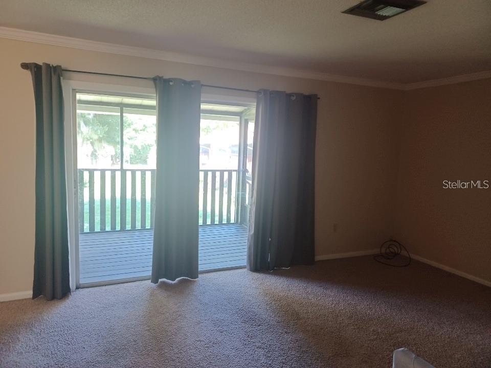 701 Perkins Street, Unit 203 Leesburg, FL 34748 - Photo 3 of 13 an empty room with windows