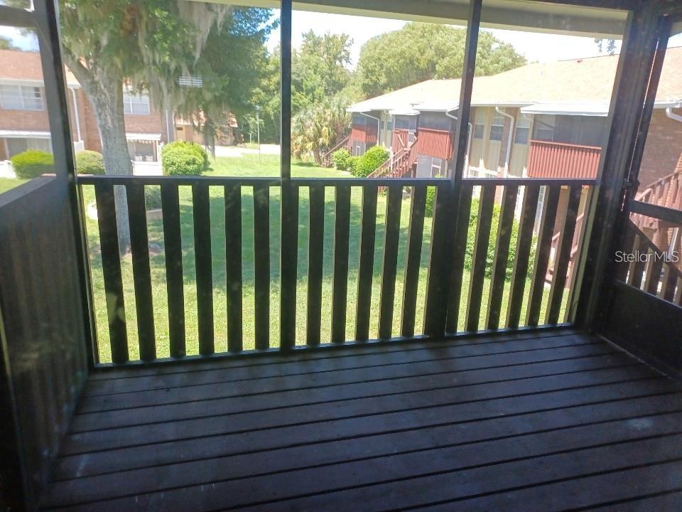 701 Perkins Street, Unit 203 Leesburg, FL 34748 - Photo 9 of 13 a view of a wooden balcony