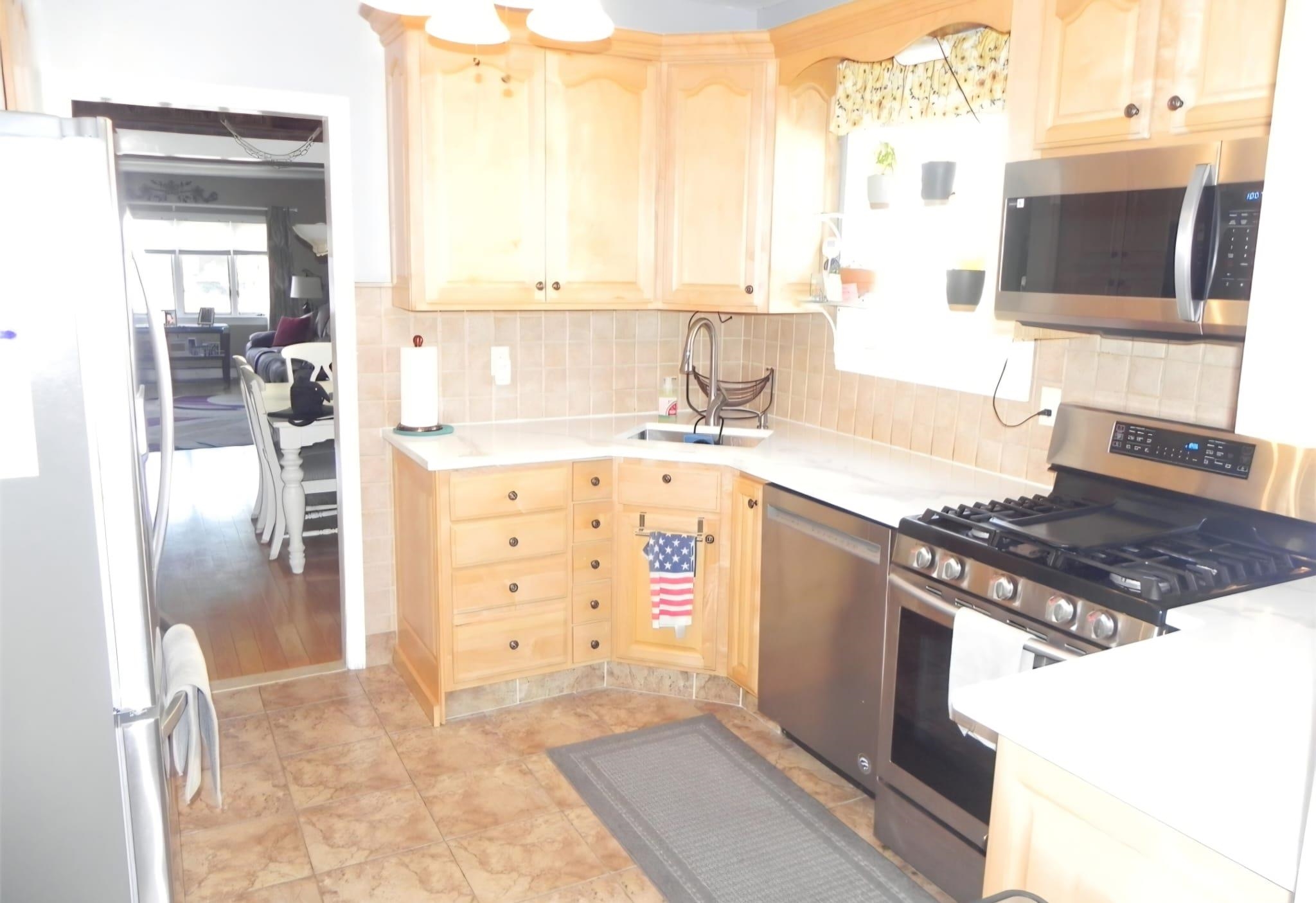 114 Mehrhof Road Little Ferry, NJ 07643 - Photo 6 of 28 a kitchen with a stove a sink and a refrigerator