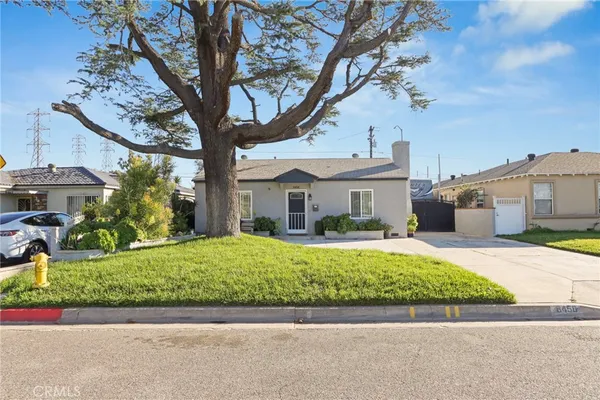 a front view of a house with a yard and a garage