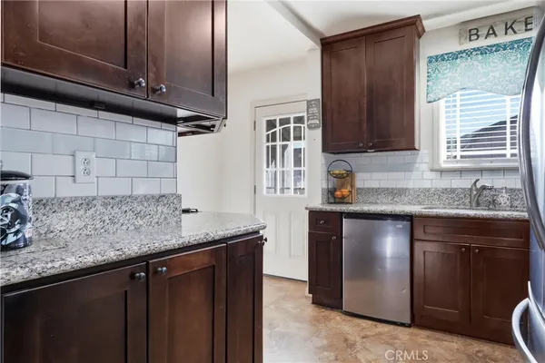 a kitchen with stainless steel appliances granite countertop a sink stove and cabinets