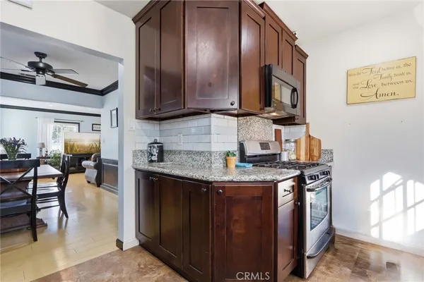 a kitchen with stainless steel appliances granite countertop a stove and a sink