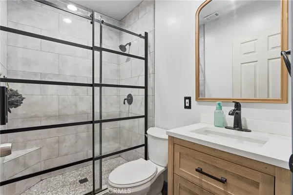 a bathroom with a toilet a sink and mirror