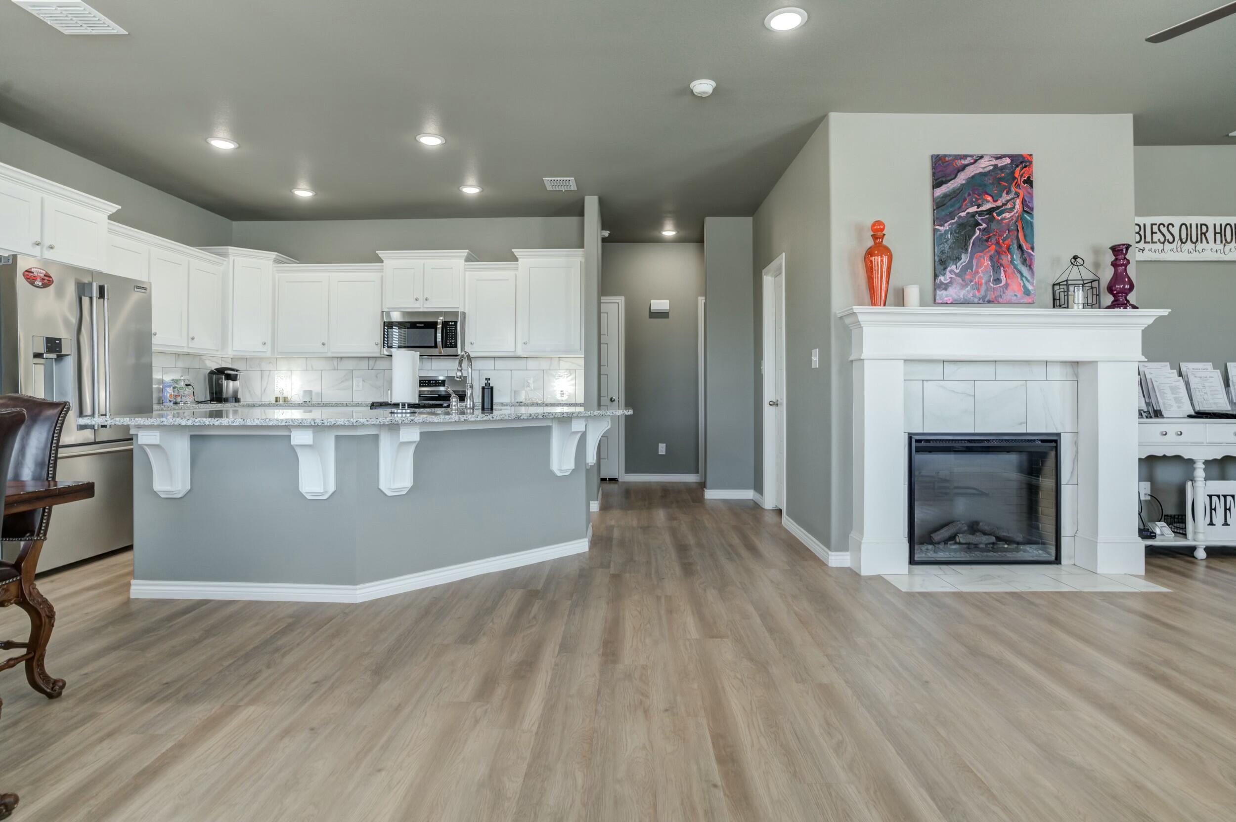 6928 11th Street Lubbock, TX 79416 - Photo 15 of 42 a view of kitchen with cabinets and wooden floor