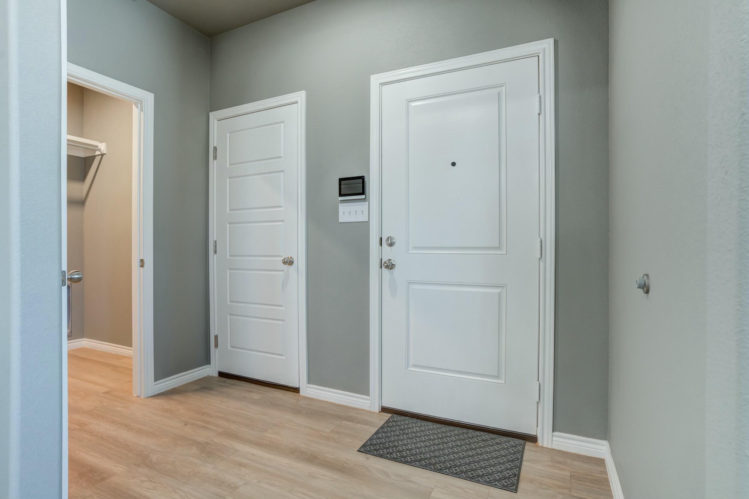 6928 11th Street Lubbock, TX 79416 - Photo 3 of 42 an empty room with wooden floor and closet area