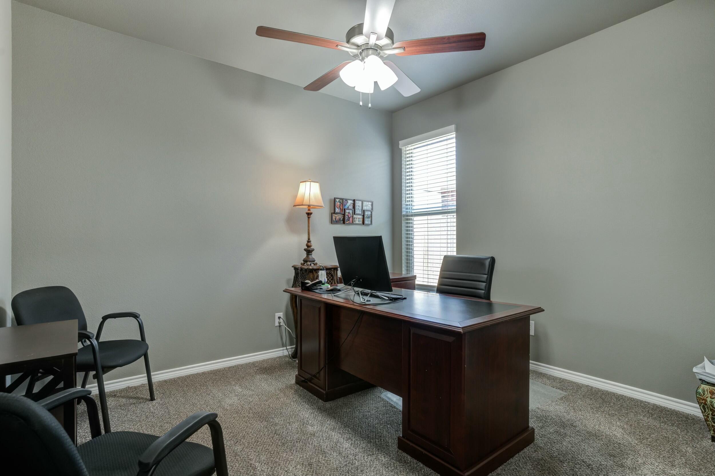 6928 11th Street Lubbock, TX 79416 - Photo 32 of 42 a view of a workspace with furniture and a window