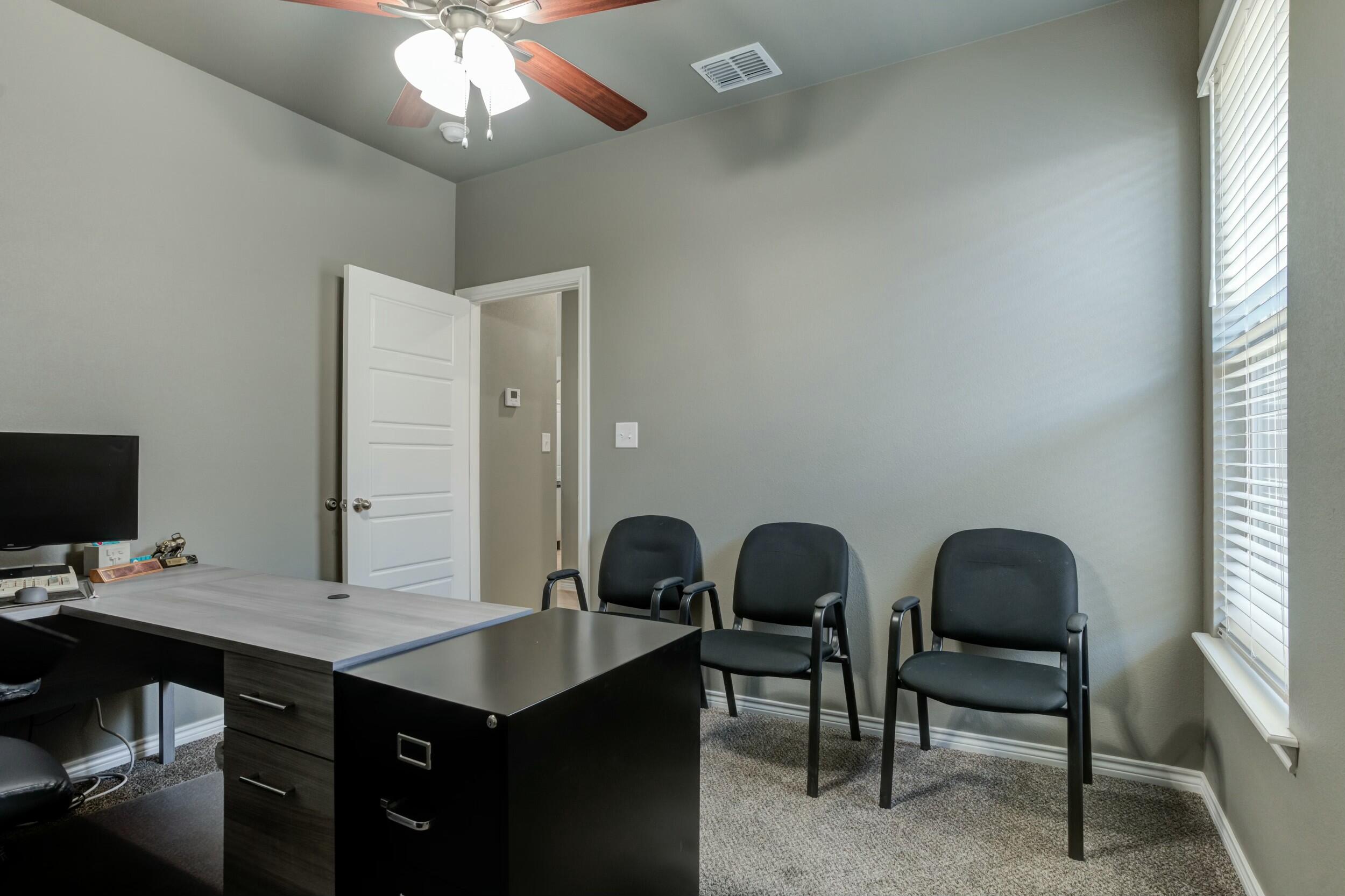 6928 11th Street Lubbock, TX 79416 - Photo 34 of 42 a view of a workspace with furniture and a window
