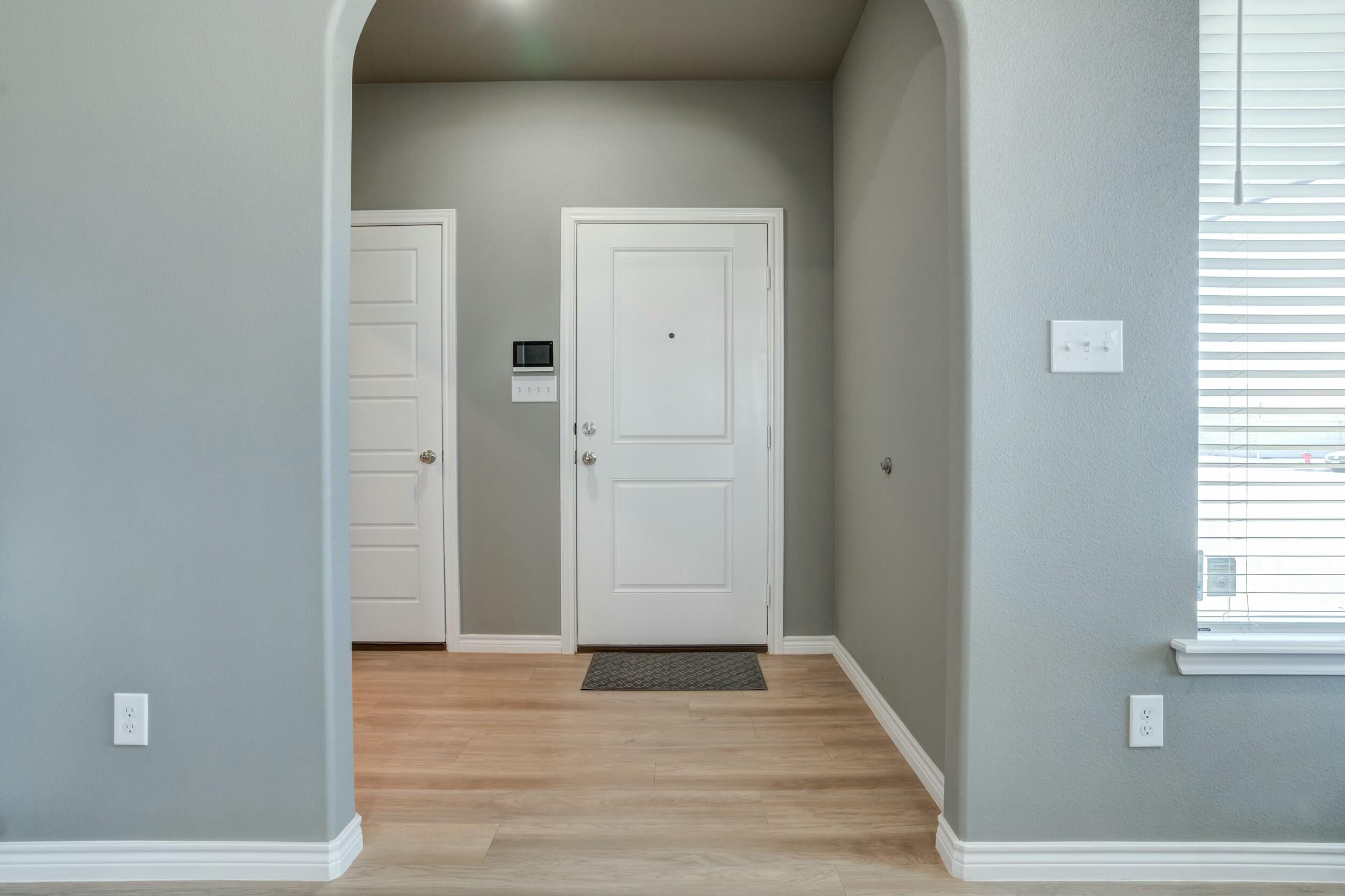 6928 11th Street Lubbock, TX 79416 - Photo 4 of 42 an empty room with wooden floor and windows