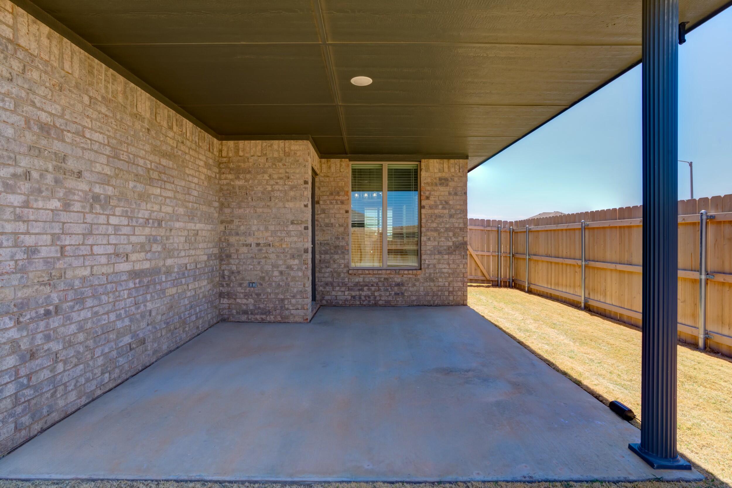 6928 11th Street Lubbock, TX 79416 - Photo 42 of 42 a view of a room with brick walls