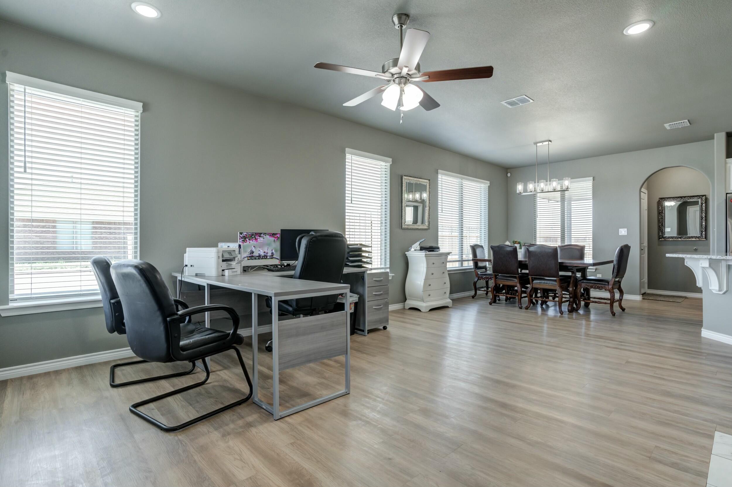 6928 11th Street Lubbock, TX 79416 - Photo 6 of 42 a view of a dining room with furniture window and wooden floor