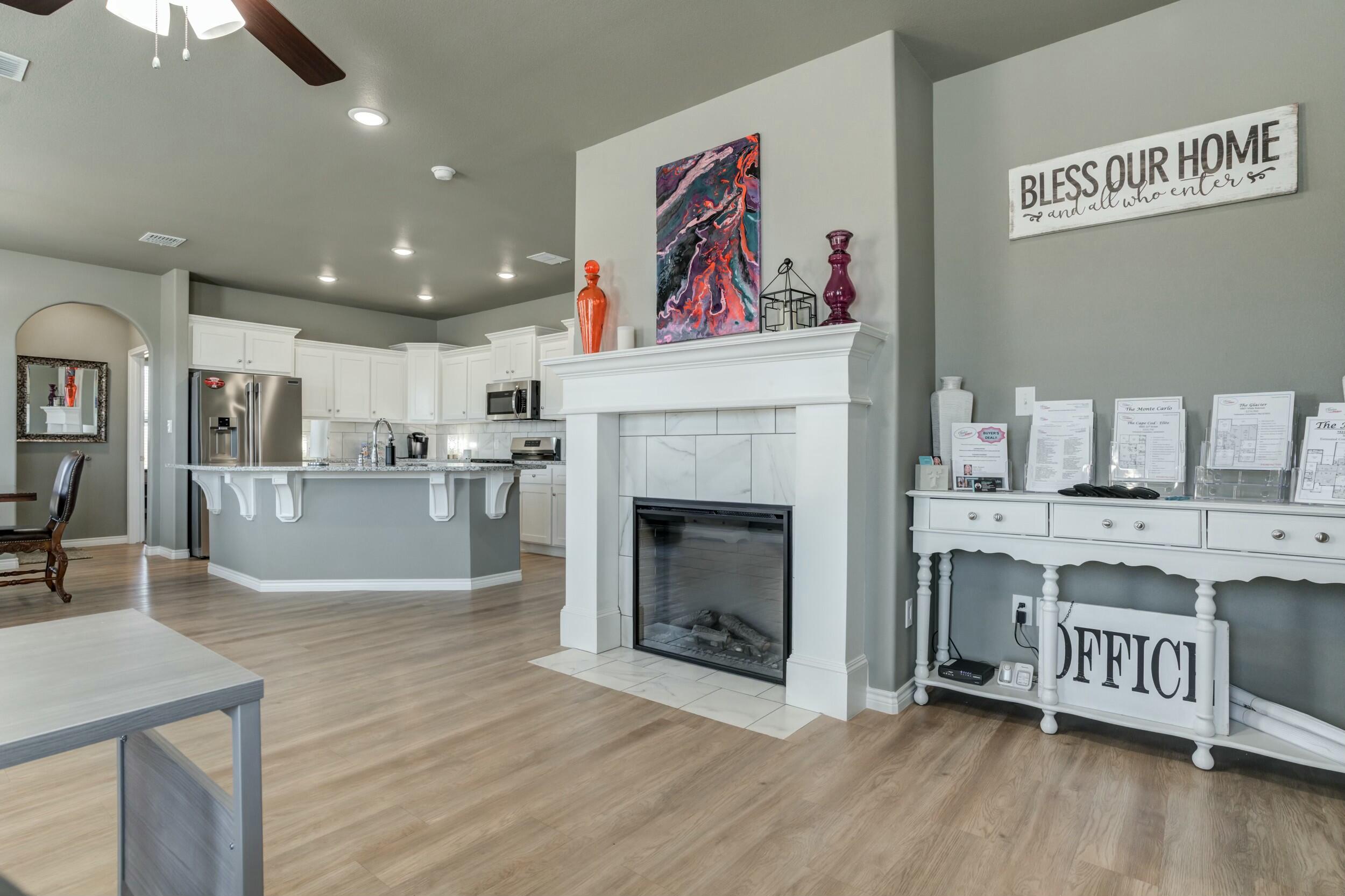 6928 11th Street Lubbock, TX 79416 - Photo 7 of 42 a living room with stainless steel appliances furniture a fireplace and a kitchen view