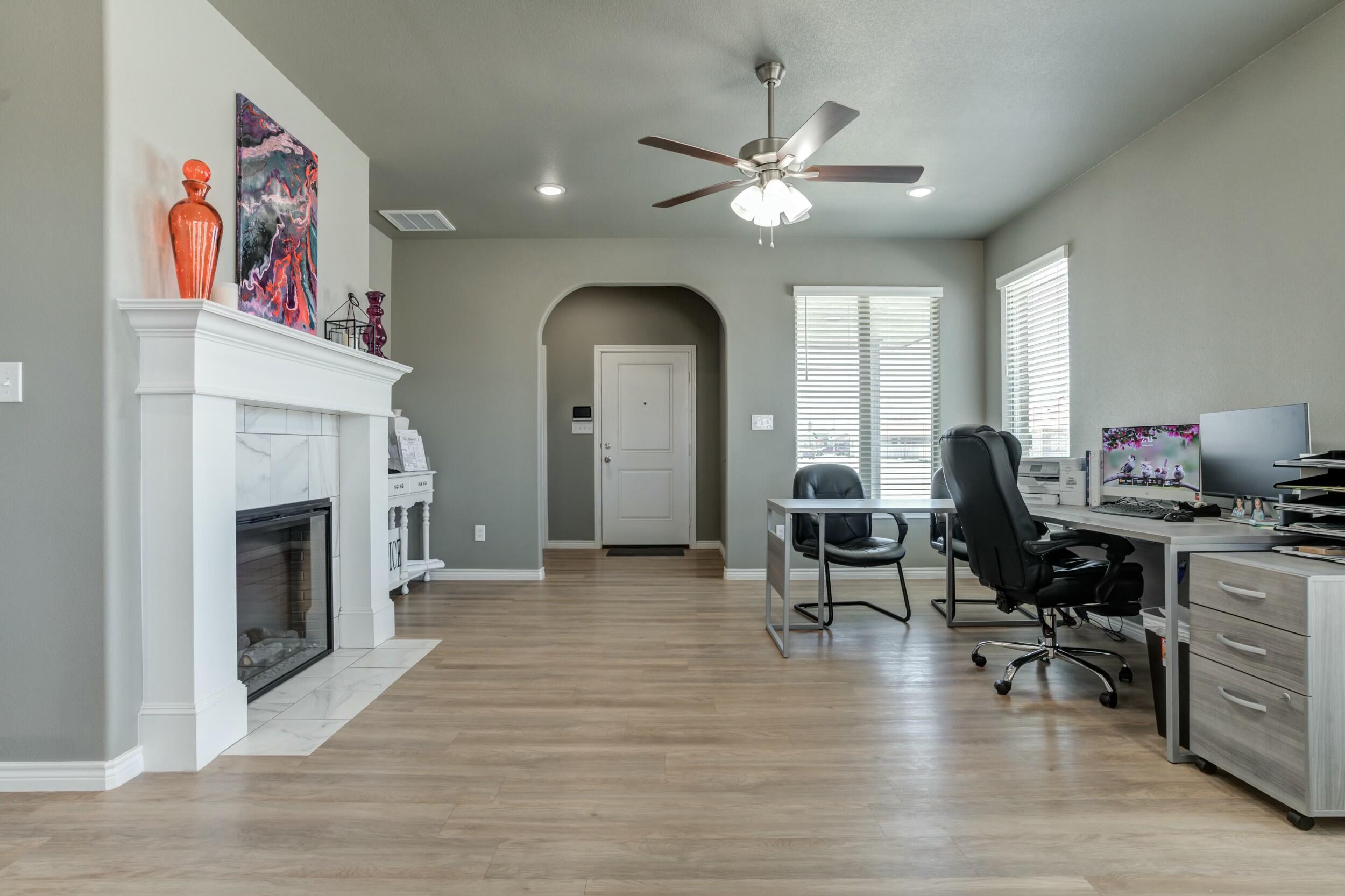 6928 11th Street Lubbock, TX 79416 - Photo 9 of 42 a living room with furniture and a fireplace