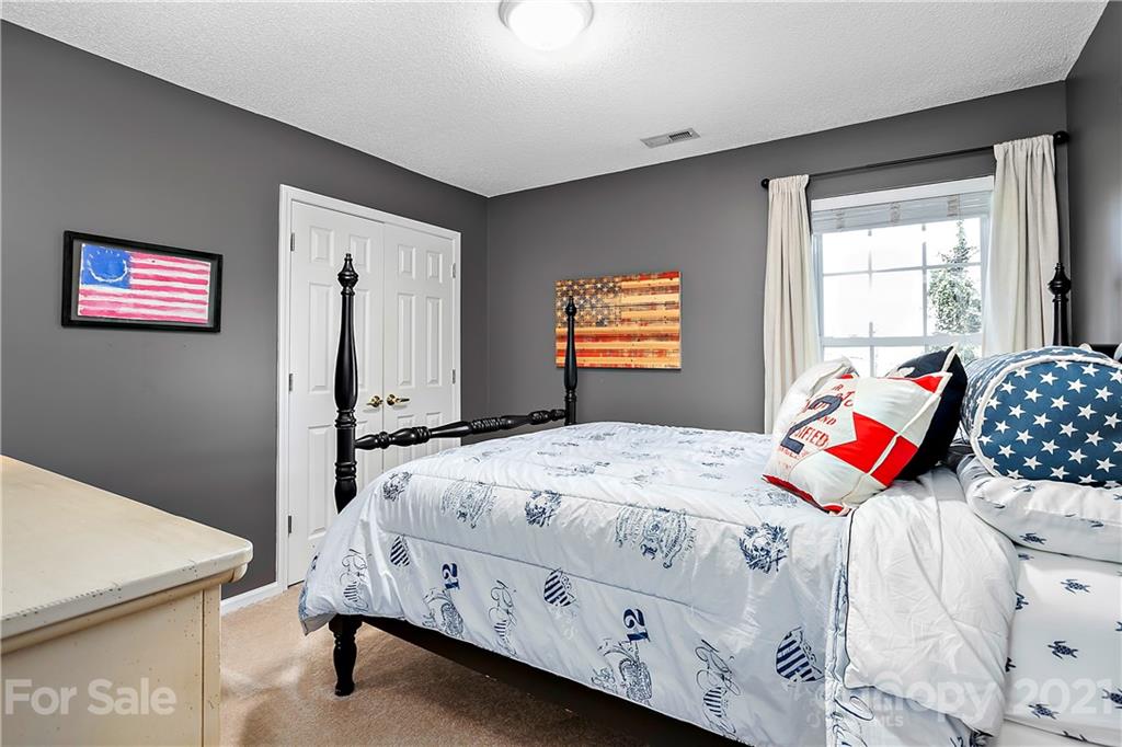 883 Knightsbridge Road Fort Mill, SC 29708 - Photo 12 of 20 a bedroom with a bed and a dresser in it