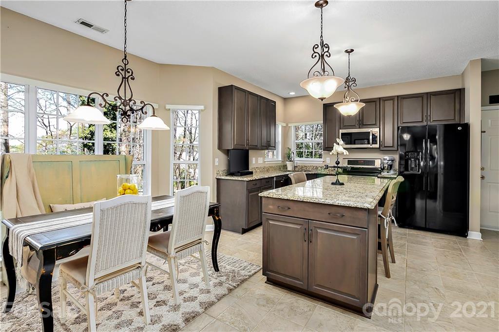 883 Knightsbridge Road Fort Mill, SC 29708 - Photo 6 of 20 a kitchen that has a table chairs appliances and cabinets