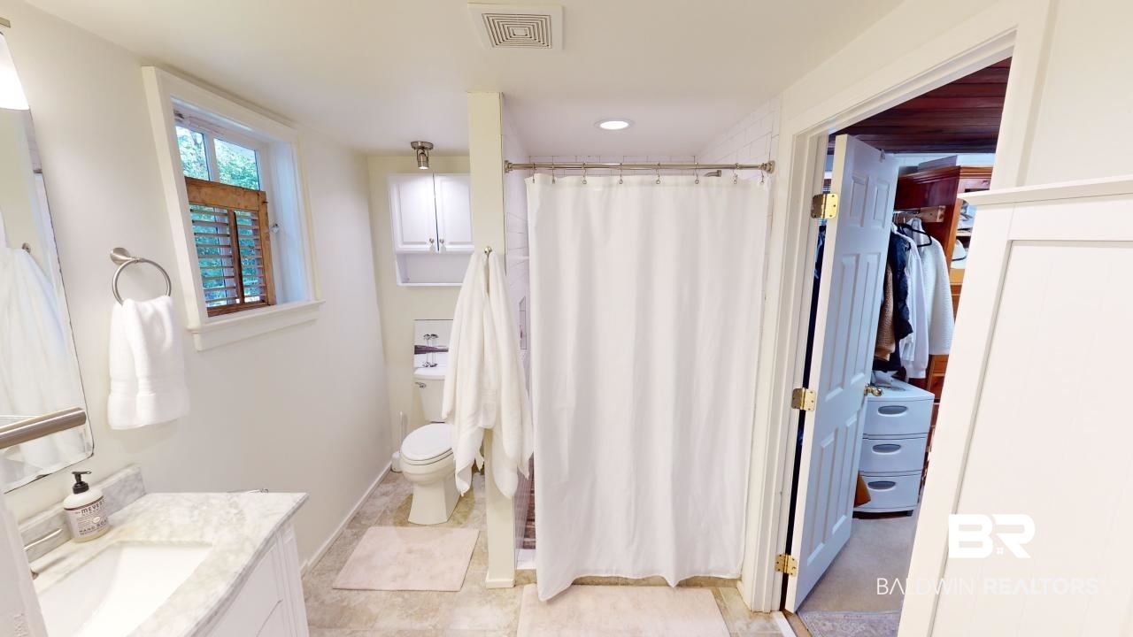 4358 Stein Street Mobile, AL 36608 - Photo 14 of 29 Bathroom with tile patterned floors, vanity, toilet, and walk in shower