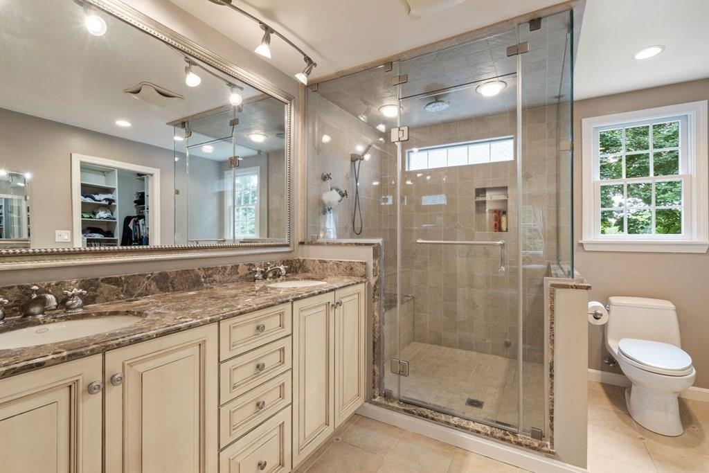 19 Shelley Road Wellesley, MA 02481 - Photo 24 of 42 a bathroom with a shower sink vanity and mirror