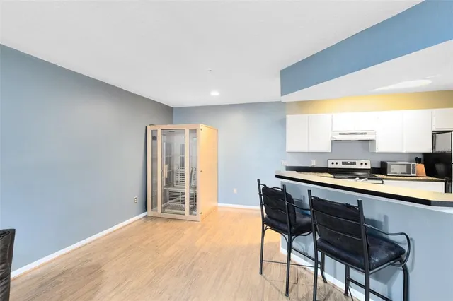 a kitchen with a sink cabinets and wooden floor