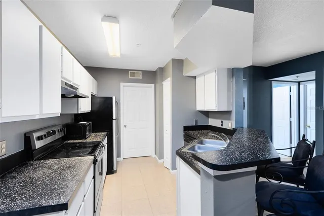 a kitchen with a stove sink and refrigerator