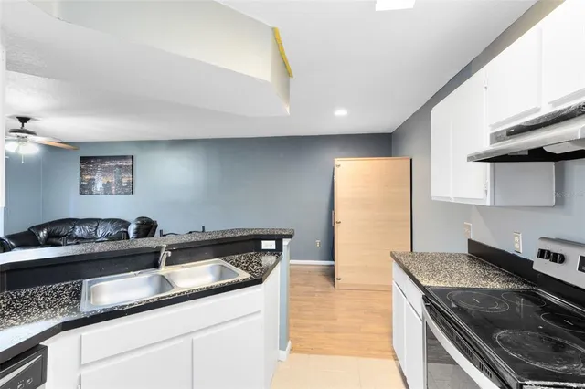 a kitchen with a sink and a stove top oven