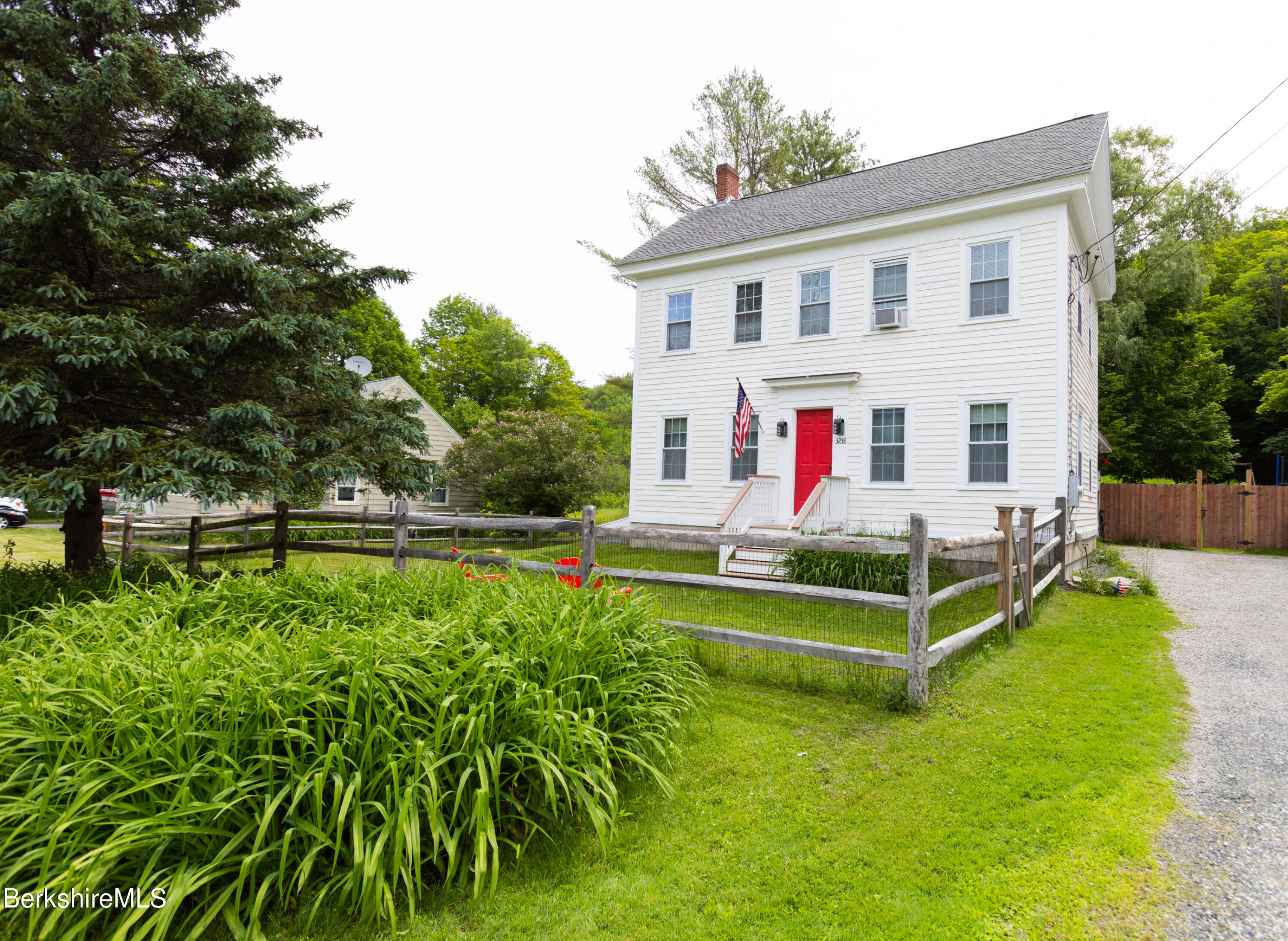 a view of house with a yard tub and chair