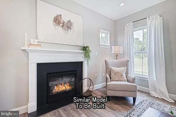 a living room with furniture a window and a fireplace
