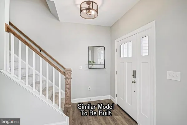 a view of an entryway with wooden floor