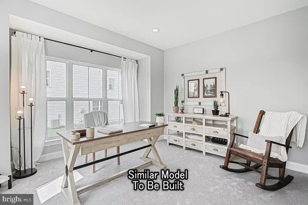 a living room with furniture a rug and a window