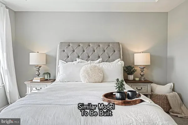 a bedroom with a bed and lamp