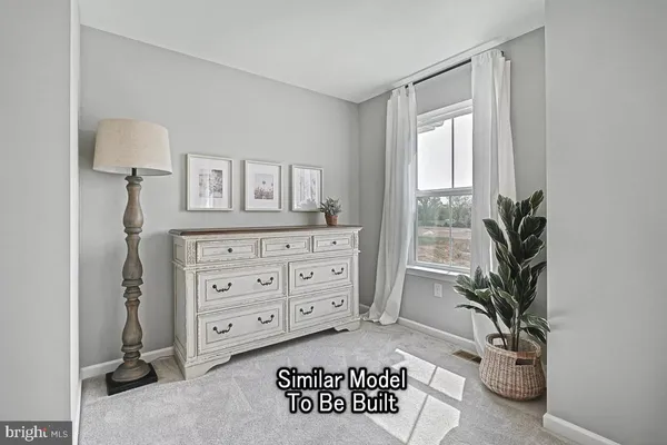 a view of a bedroom with a window and furniture