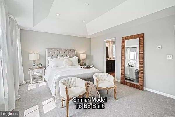 a bedroom with a bed and table chair