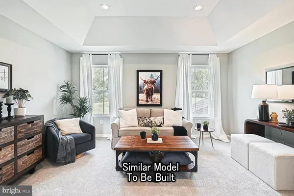 a living room with furniture a table and a large window