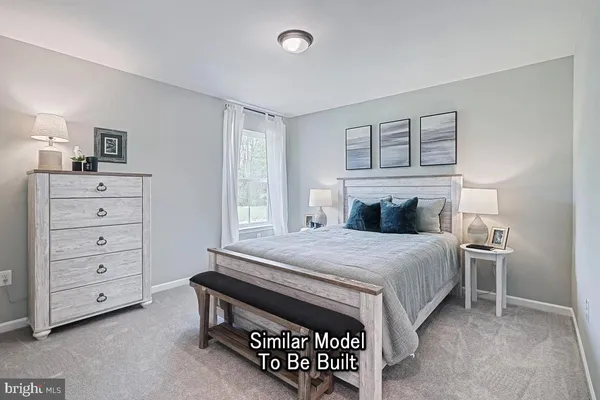 a bedroom with a bed and a dresser in it