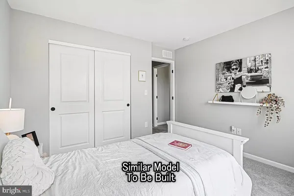 a bedroom with a bed and a cabinets