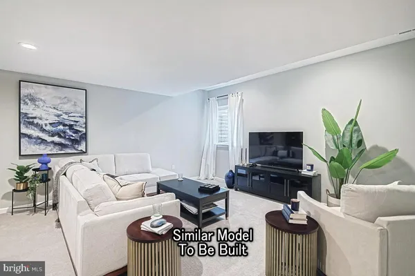 a living room with furniture a flat screen tv and a potted plant