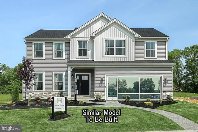 a front view of a house with a yard table and chairs