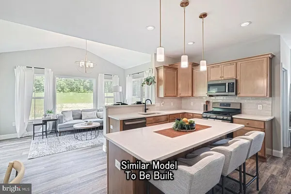 a kitchen with a appliances a dining table and chairs