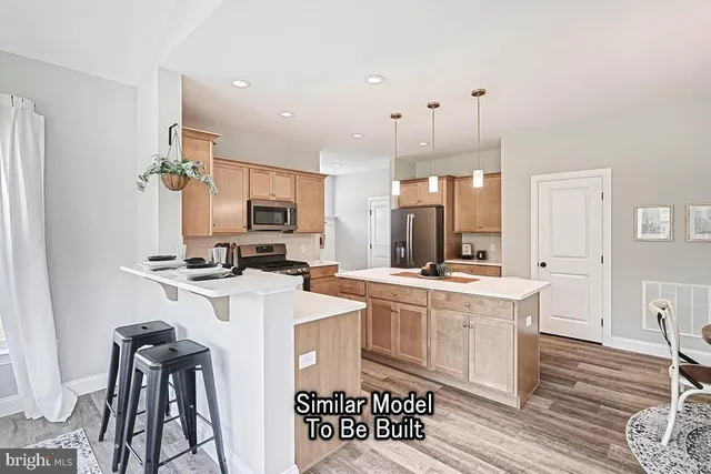 a kitchen with stainless steel appliances a stove a sink dishwasher and a refrigerator