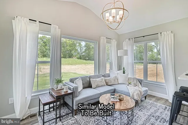a living room with furniture chandelier and a table