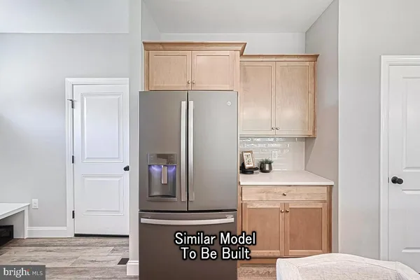 a kitchen with a refrigerator and cabinets