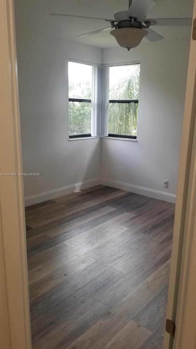 Jacaranda Plantation, FL 33322 - Photo 11 of 12 an empty room with wooden floor and windows