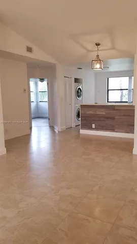 a kitchen with stainless steel appliances granite countertop a refrigerator sink and microwave