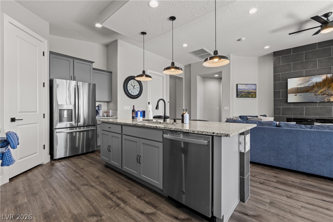 1436 Manassas Ridge Mesquite, NV 89027 - Photo 27 of 77 Granite counters and recessed lighting elevate this open-concept kitchen with seamless living area integration.