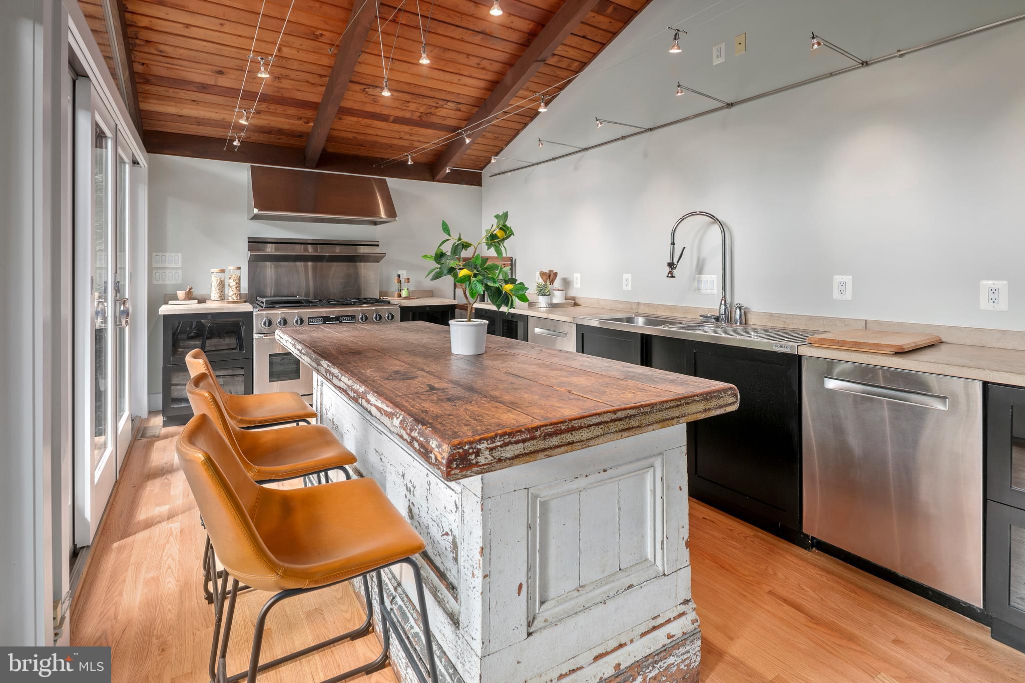 2825 Lorcom Lane Arlington, VA 22207 - Photo 37 of 63 a kitchen with stainless steel appliances granite countertop a sink stove and cabinets