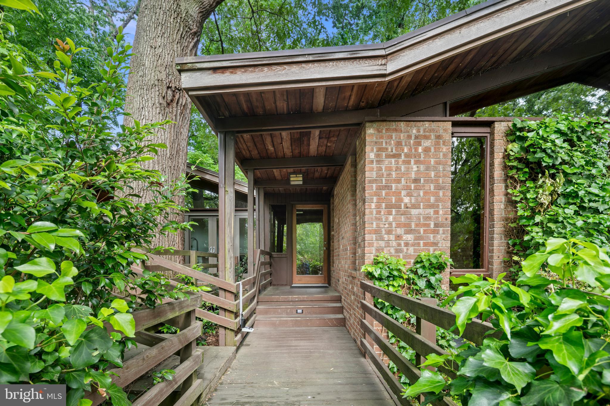 2825 Lorcom Lane Arlington, VA 22207 - Photo 6 of 63 a view of a pathway of the house with potted plants